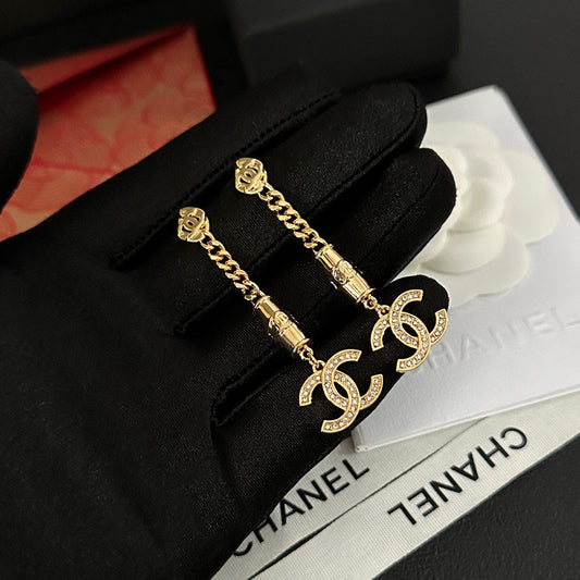 Boucles d'oreilles pendantes en strass doré