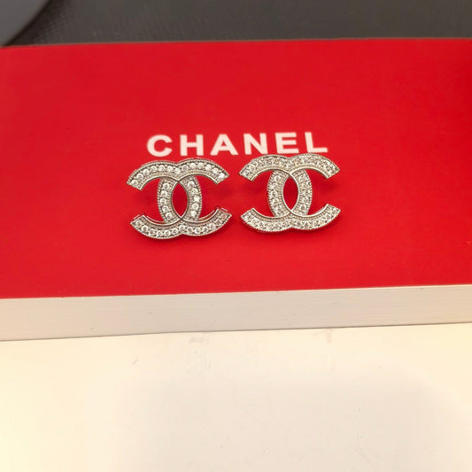 Boucles d'oreilles élégantes en argent et or avec logo
