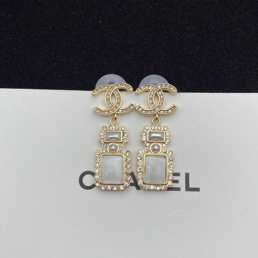 Boucles d'oreilles pendantes élégantes en forme de flacon de parfum