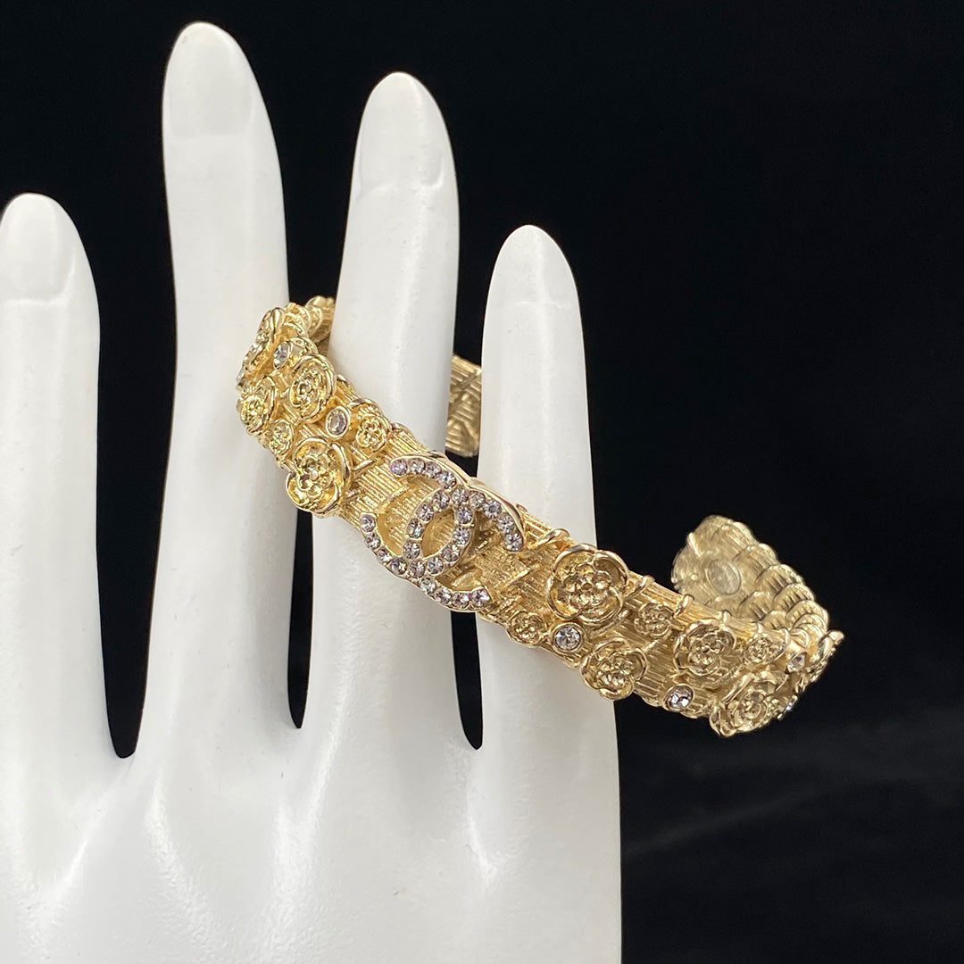 Pulsera abierta de camelia grabada en relieve