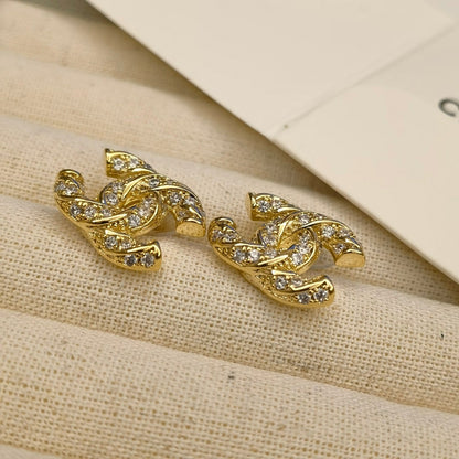 Clous d'oreilles logo étincelants en zircon